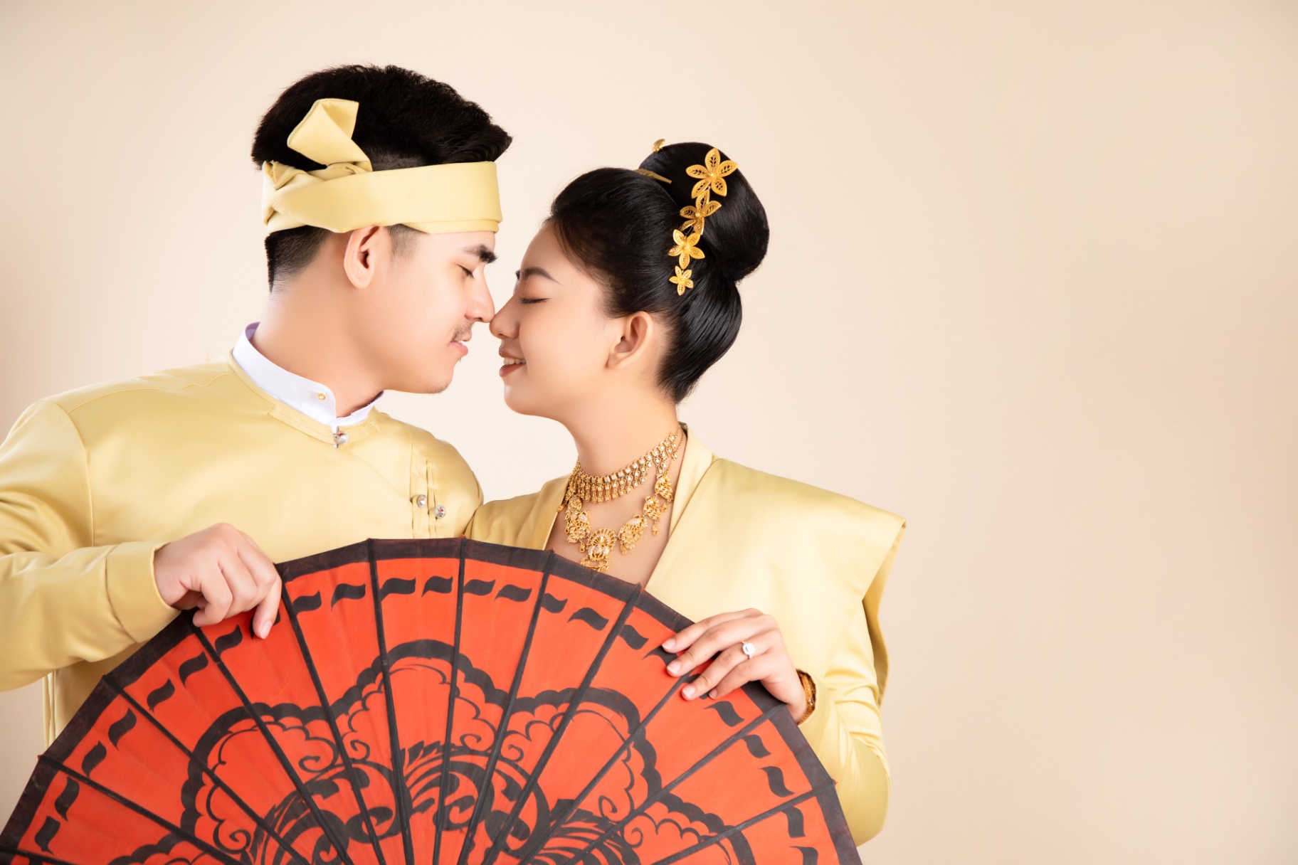 Traditional Myanmar close portrait behind a red parasol